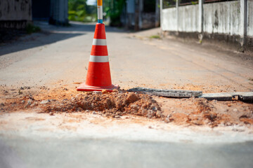 traffic cone on damaged road surface