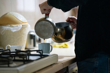 person in the kitchen makeing turkish tea