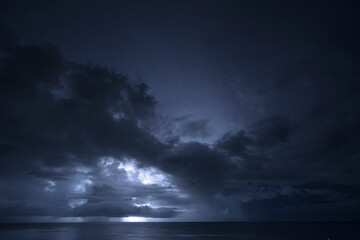 Fototapeta na wymiar Nightshot: flashes of lightning in thunderstorm scenery around Curacao, the Caribbean