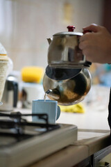 person in the kitchen makeing turkish tea