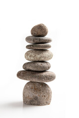 Fototapeta na wymiar Five smooth granite pebbles balanced precariously on top of each other in order of size, on a white background