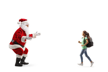 Full length profile shot of a girl with a backpack running towards santa claus
