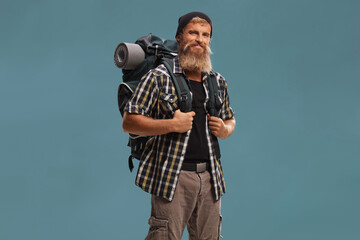 Fototapeta premium Smiling bearded hiker with a backpack posing
