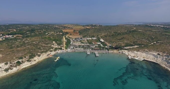 Aerial Top Down View Shot of a Person Jet Skiing in Circles. Beautiful Blue Oceanic Waters and Sun is Shining. 