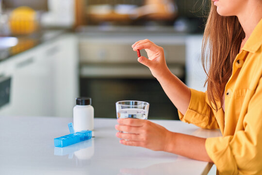 Person Taking Medicine At Home