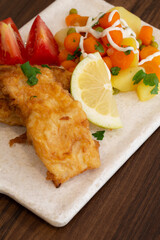 Fried hake fillet with potatoes and vegetables served and ready to eat, Braga, Portugal.