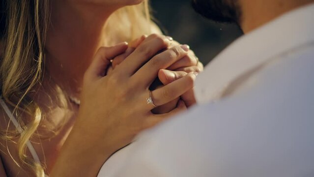Hands of man and woman with wedding rings, groom and bride standing on ceremony. Newlywed couple exchanging rings on wedding ceremony. Unrecognizable groom holding bride hand.