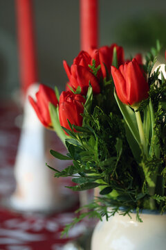 Multiple red tulips in a closeup. Tulip bouquet indoors. Flower that can symbolize love, Christmas, Easter or even Netherlands. Bright colorful spring season flowers blooming. Color image.