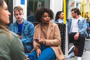 Multiracial people travelling by tube in London