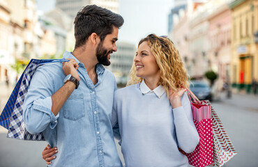 Young couple in shopping. Consumerism, love, dating, lifestyle concept
