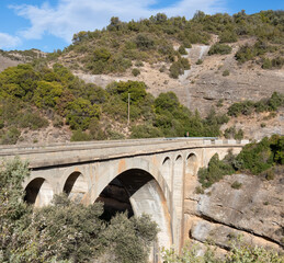 arch span bridge crossing a gorge and river beneath, Pyrenees mountains, Spain