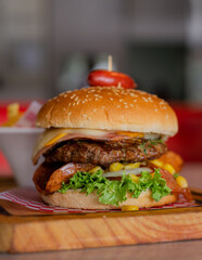 Beef burger with chicken, ham, cheese, sausage, vegetables and French fries