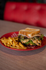 Chicken sandwich with French fries served on a plate