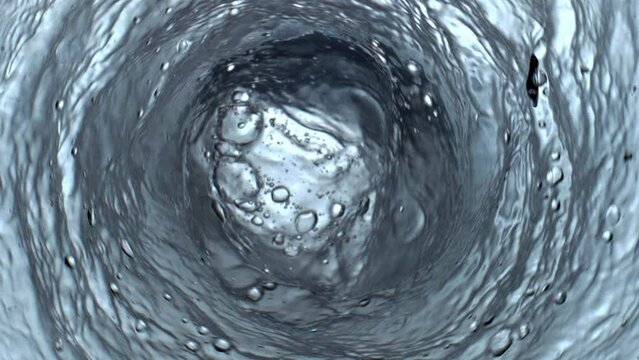 Sparkling gin tonic swirling in glassware top view. Carbonated cocktail funnel