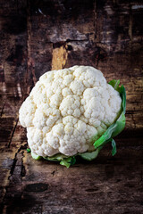 Close up of cauliflower isolated on dark wood background