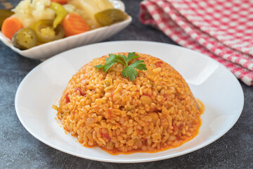 Traditional turkish bulgur pilaf with tomato sause in plate (Turkish name; meyhane pilavi)