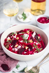 Beetroot pasta with cheese feta in a bowl. Bright background.