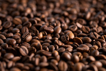 Large roasted coffee beans scattered on the table