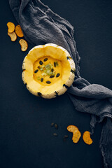 Pumpkin cream soup served in squash with seeds