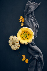 Pumpkin cream soup served in squash with seeds