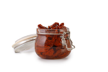 Sun dried tomatoes with olive oil in glass jar isolated on a white background, clipping path, cut out. Sun-dried tomatoes, preserves.