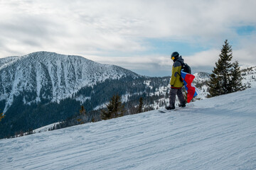 Fototapeta na wymiar man snowboarder with slovakia flag at ski resort slope