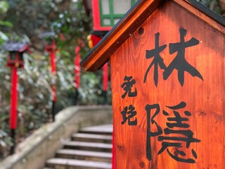 Closeup shot of  Chines hieroglyphs on a small wooden house in the park