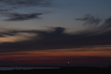 Amazing Black sea sunset, Desert and sand landscape. Drama sky ,sun and clouds. Blue hour at the ocean romantic evening. Ship on the horizon. Tropical island summer paradise. Lighthouse