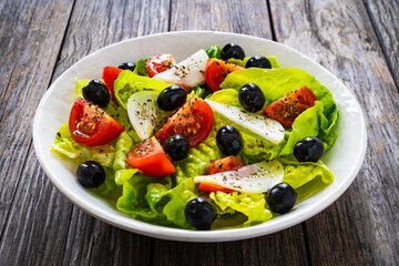 Fresh vegetable salad on wooden table
