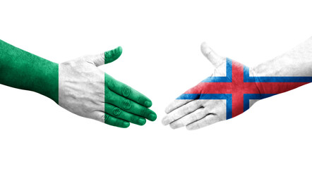 Handshake between Faroe Islands and Nigeria flags painted on hands, isolated transparent image.