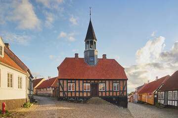 Fototapeta na wymiar Ebeltoft, Denmark, September, 2022: Ancient chapel on a cozy street at sunset