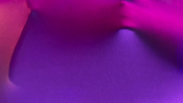 elastic fabric with a face behind it. movement of the face of an unknown person behind the fabric.colored background. High quality FullHD footage