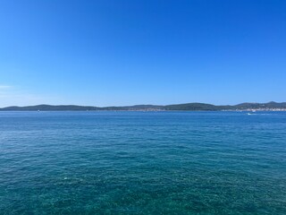 Blue sea horizon, blue sky, natural colors, pure sea water surface