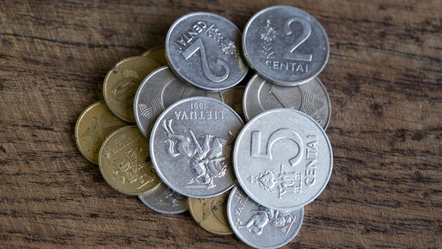 Various old Lithuanian coins isolated on wooden background