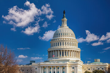 Fototapeta na wymiar US Capitol over blue sky at sunny day