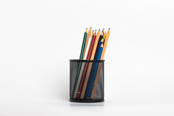 Fototapeta premium black pen holder full of colored pencils isolated on white background , Education consept idea
