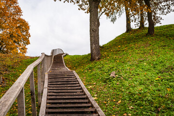 Fototapeta na wymiar Steep wooden stairs to a hill near Dubingiai, Lithuania