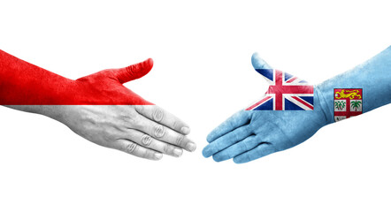 Handshake between Fiji and Indonesia flags painted on hands, isolated transparent image.