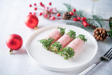 Ham cheese garlic rolls decorated with dill and cream sauce