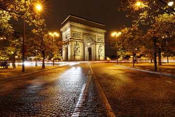 The Triumphal Arch in rainy evening, Paris, France.