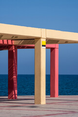 Colorful beach shade umbrella shade with concrete pillars
