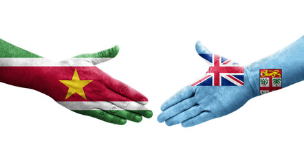 Handshake between Fiji and Suriname flags painted on hands, isolated transparent image.