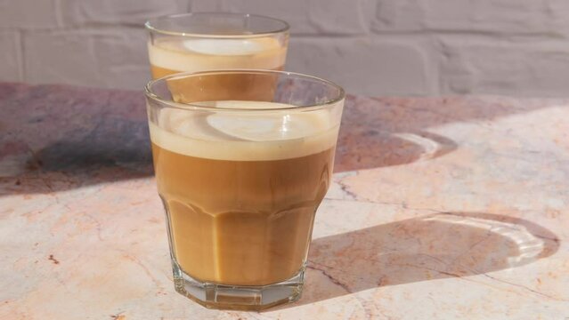 cortado coffee in a glass glass on a stone table. Spanish coffee	