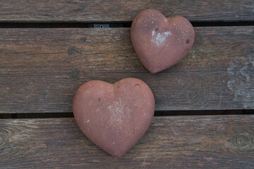 stone hearts on wooden background