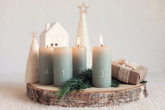 Handmade modern advent wreath with four candles lit every sunday before christmas. Traditional diy xristmas decoration