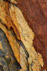 Natural rock texture of a colorful rock formations in silence beach (playa del Silencio) in Asturias, north of Spain.