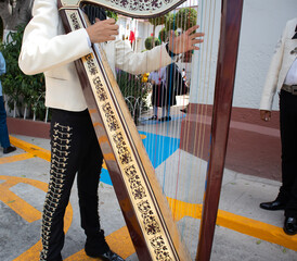 Mariachi playing mexican music with a mariachi harp