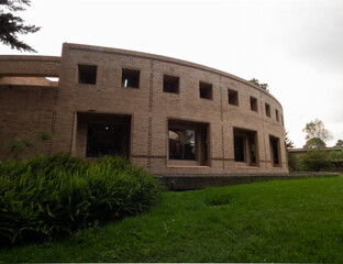 front of the Salmona building with a fern in the foreground (National University of Colombia)