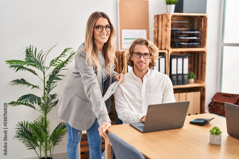 Poster man and woman business workers using laptop working at office