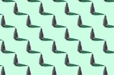 Pattern of christmas trees on green pastel background